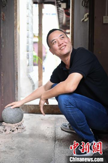 廖奕铭向记者讲述这块挡门石的故事。 陈楚红 摄 廖奕铭向记者讲述这块挡门石的故事。 陈楚红 摄